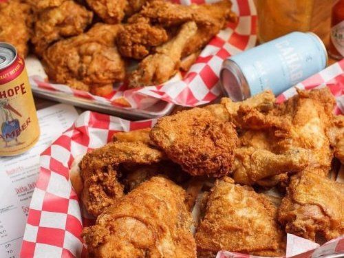 Baskets of fried chicken on red checkered paper