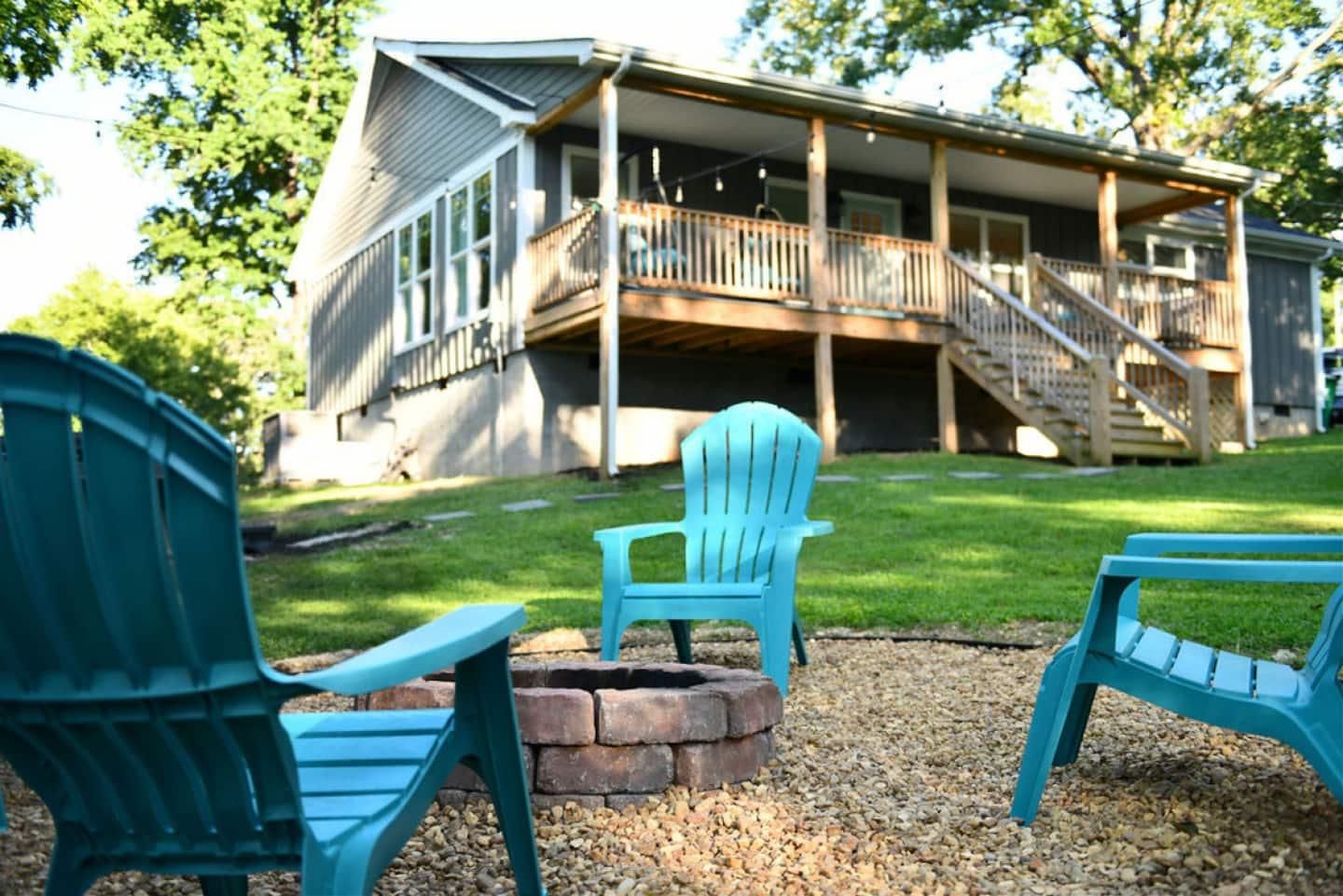 Teal chairs around the stone fire pit
