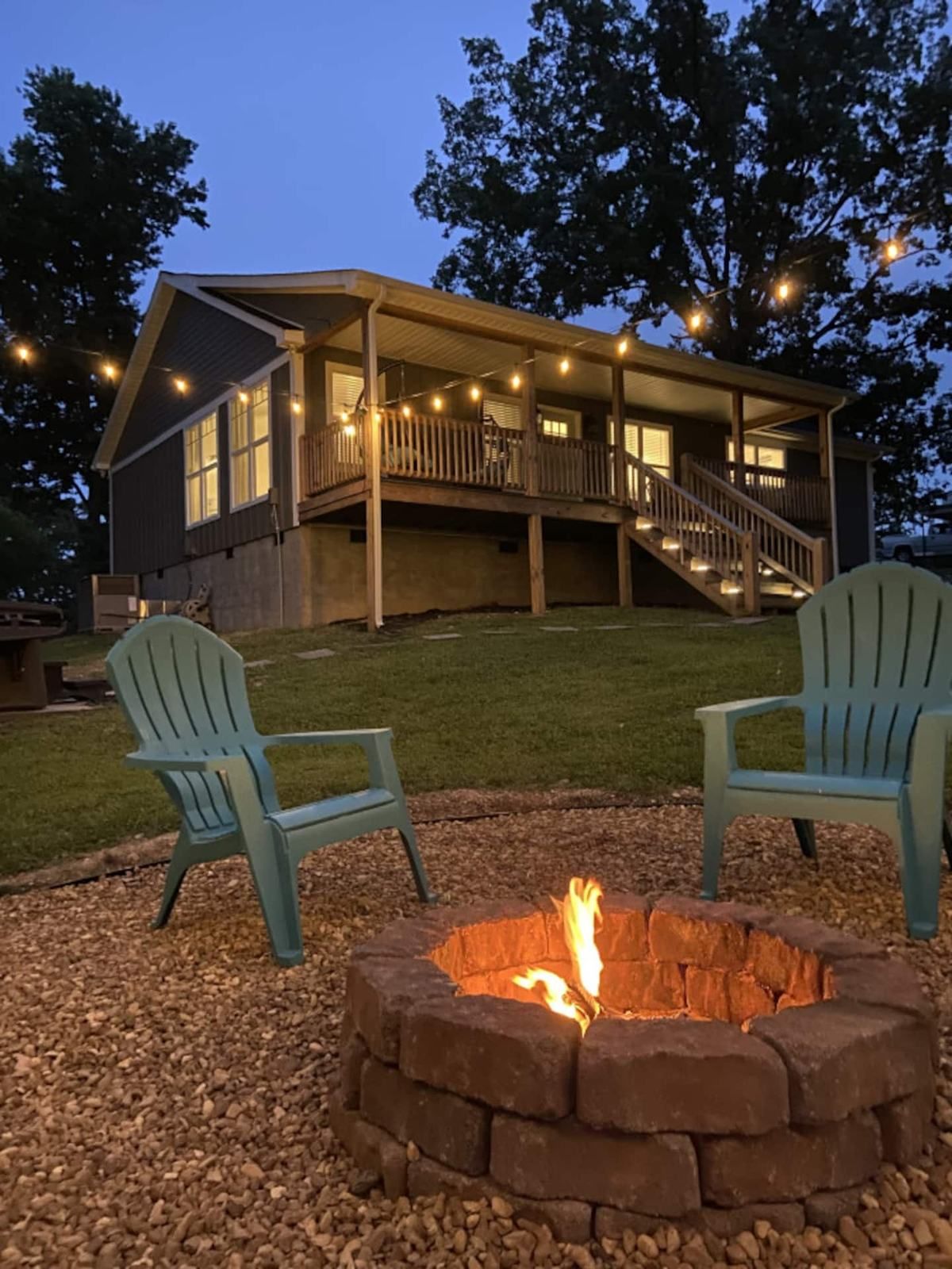 The house at dusk with the fire pit lit