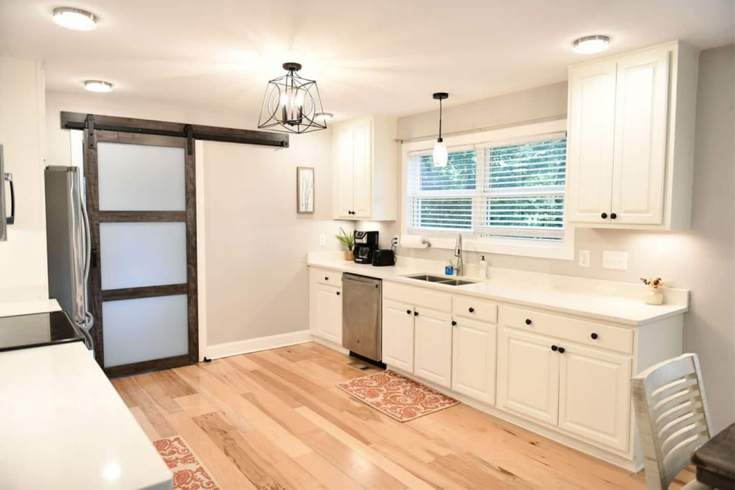 White kitchen with a sliding barn door